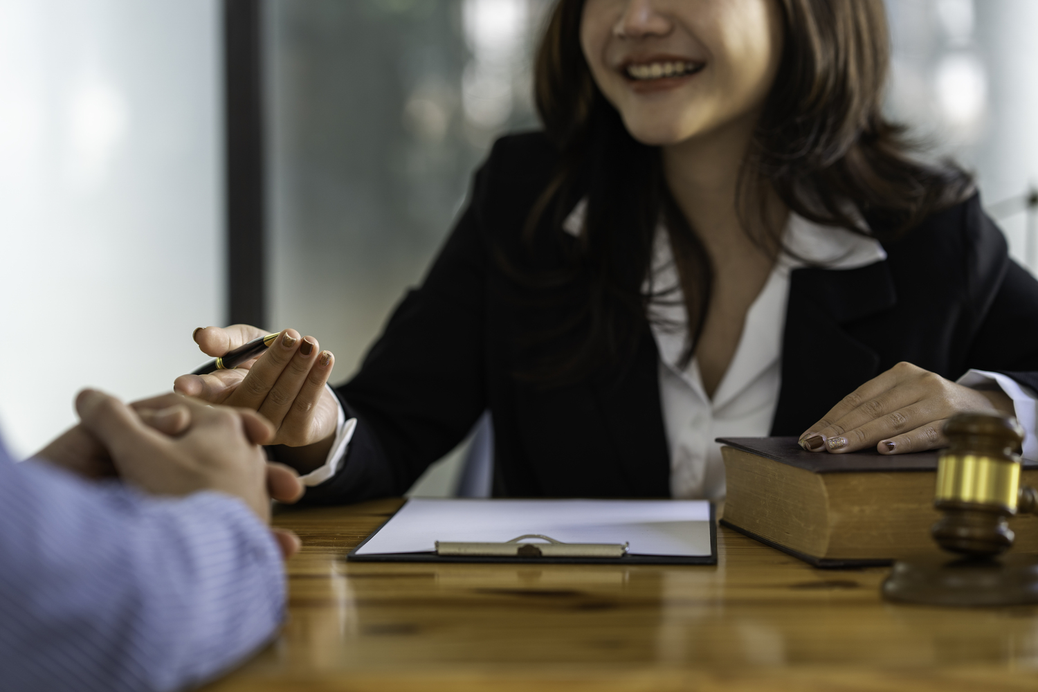 Dallas attorney meeting with client for free legal consultation with gavel and legal documents on desk
