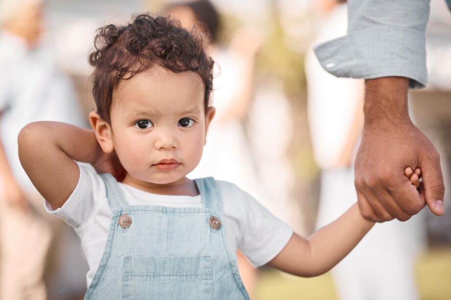 Young child holding parent's hand representing child financial wellbeing in Dallas child support cases