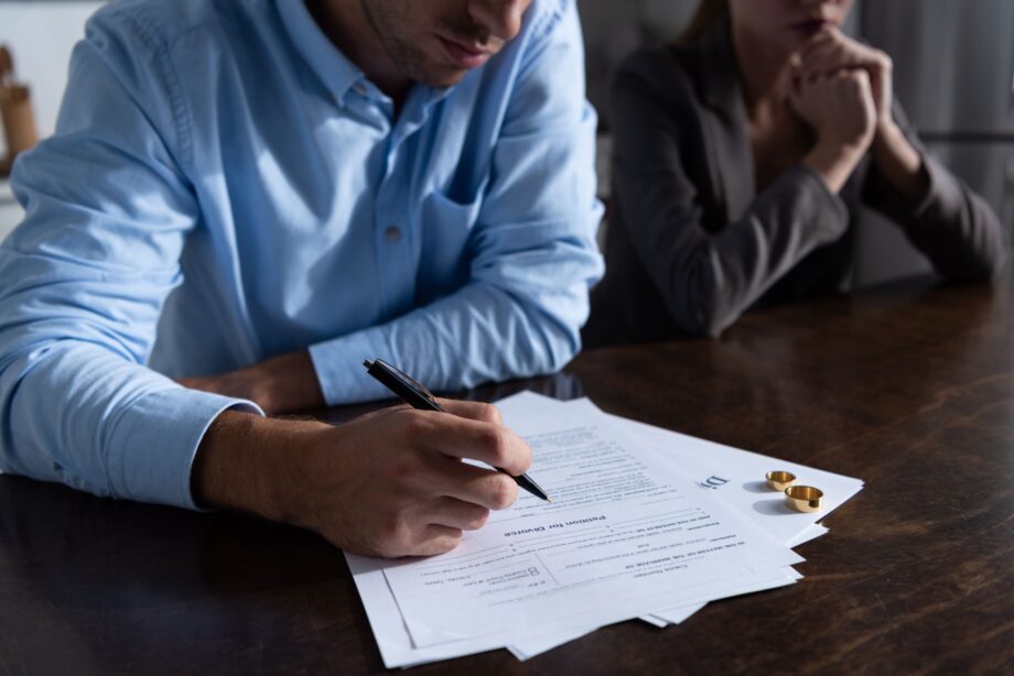 Couple signing divorce settlement documents in Texas