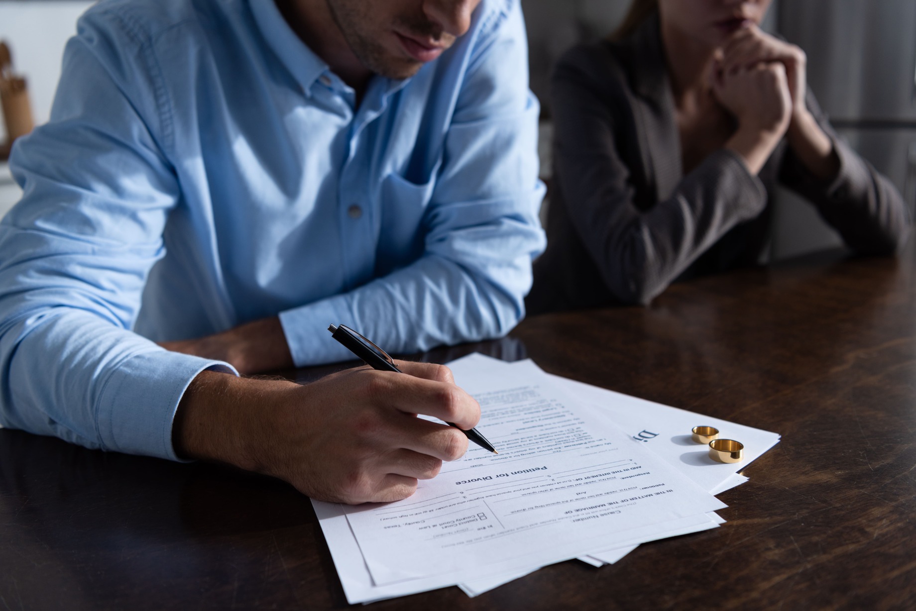 Couple signing divorce settlement documents in Texas