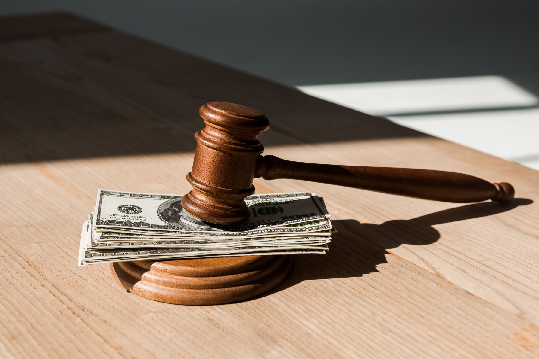 Gavel next to cash, representing legal fees in a DWI case