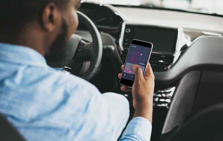 Rideshare driver app open on phone during a trip in Dallas