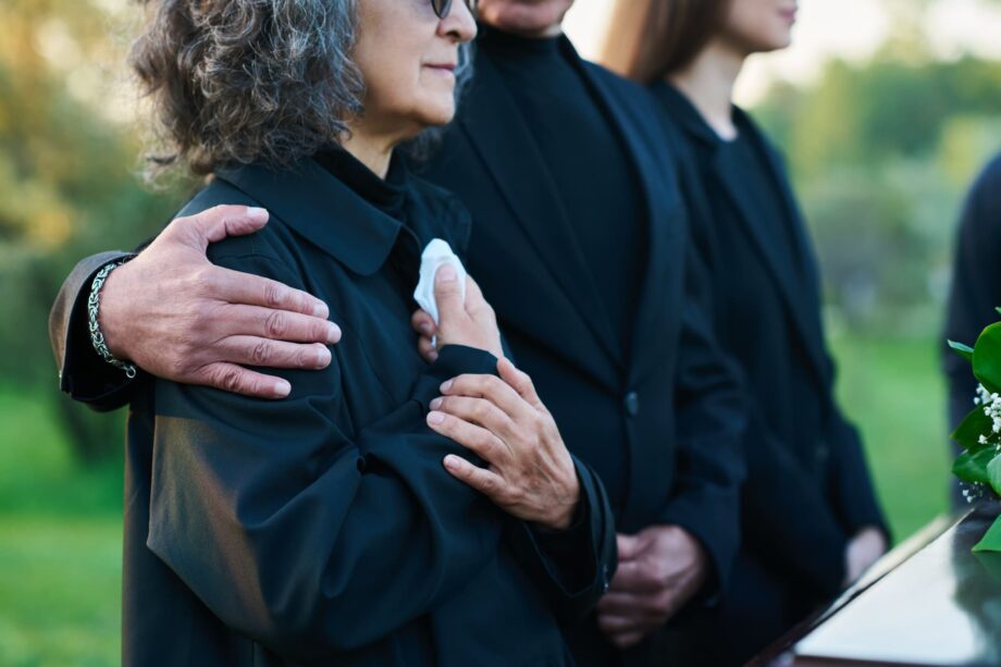 Family members dressed in black comforting each other at a funeral representing the right to file a wrongful death claim in Texas after a tragic loss
